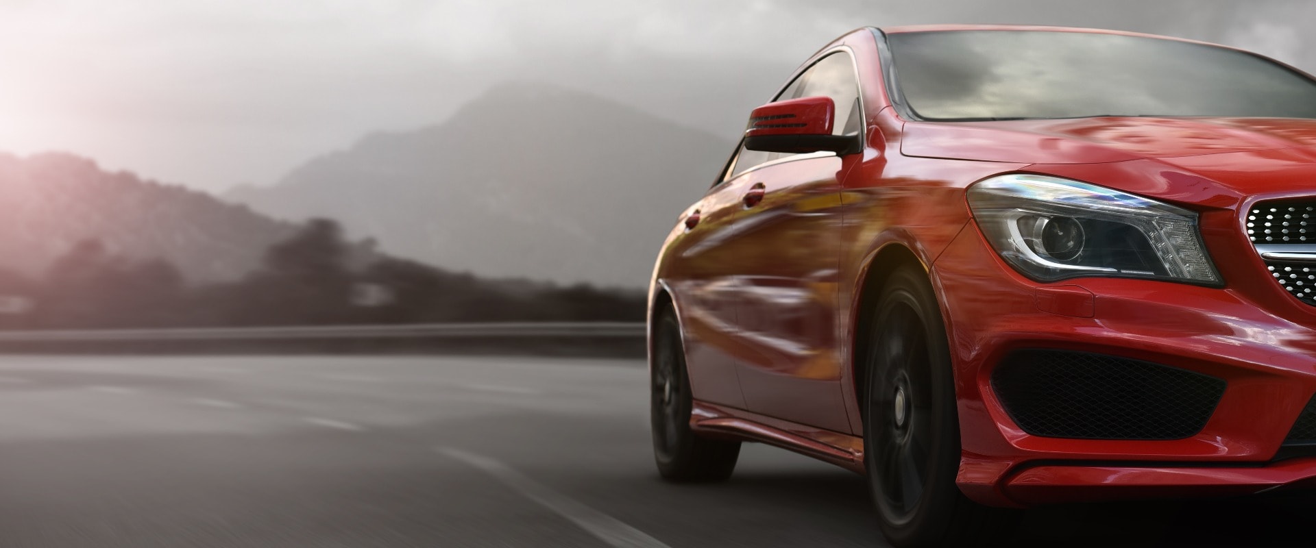 red business car speeding on a mountain highway with motion blur